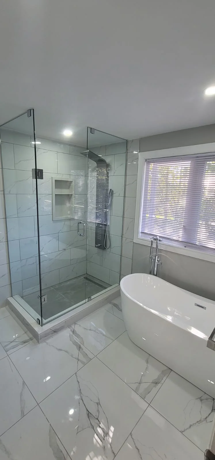 Renocare bathroom renovation with freestanding tub and glass shower